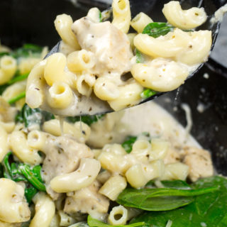 This Cheesy Chicken and Spinach Pasta is a quick one-pan dinner that is made with kitchen staples and only takes 30 minutes!