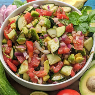 Delicious side salad packed with fresh cucumbers, tomatoes, avocado, basil, and more! Paleo, Whole30, and Vegan friendly as well as dairy-free, gluten-free, and sugar-free. Easy, satisfying, and only 8 ingredients.