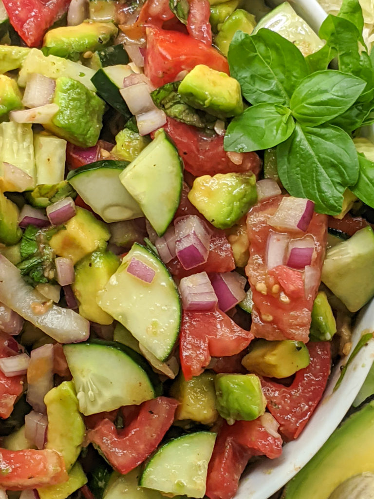 Delicious side salad packed with fresh cucumbers, tomatoes, avocado, basil, and more! Paleo, Whole30, and Vegan friendly as well as dairy-free, gluten-free, and sugar-free. Easy, satisfying, and only 8 ingredients. 