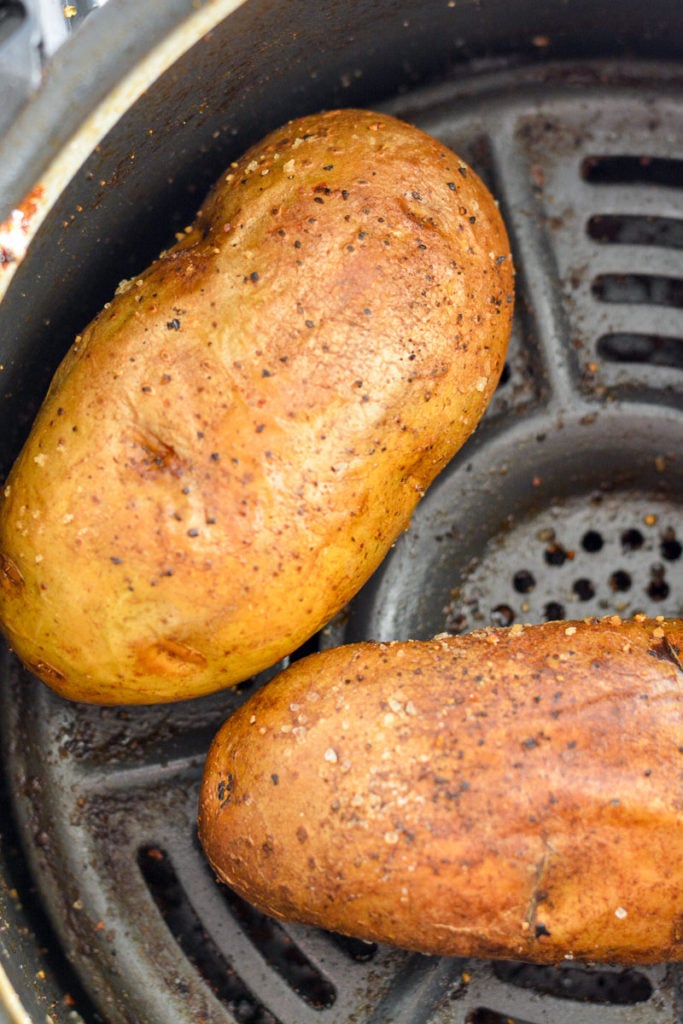Air Fryer Baked Potatoes have a super crispy outside, soft, fluffy & tender inside and only take 40 minutes. 