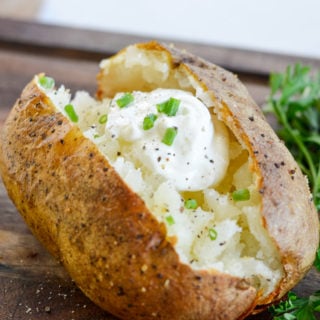 Air Fryer Baked Potatoes have a super crispy outside, soft, fluffy & tender inside and only take 40 minutes.