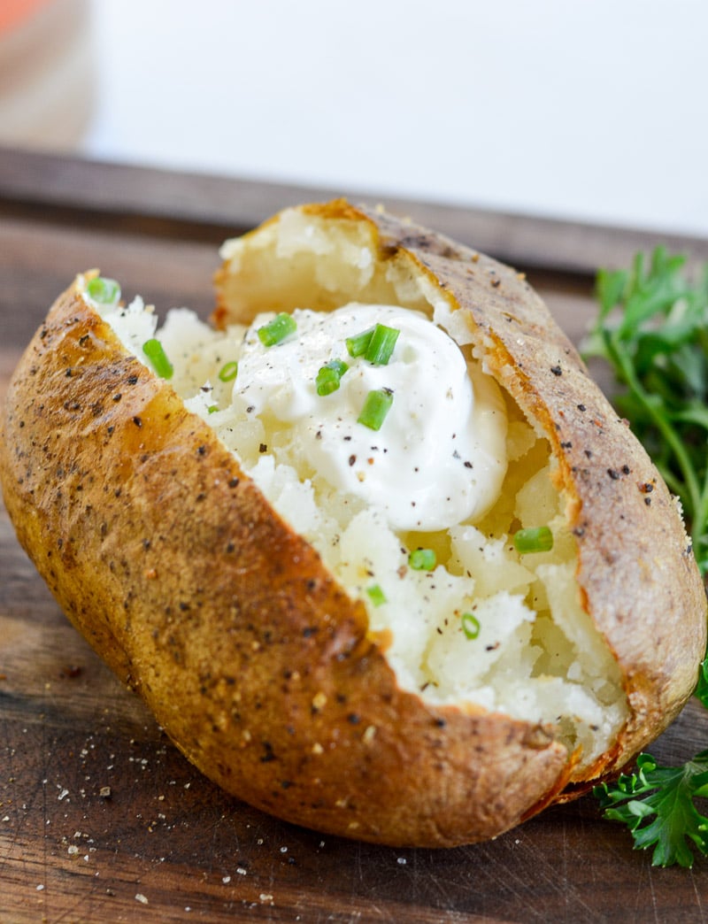 Air Fryer Baked Potatoes have a super crispy outside, soft, fluffy & tender inside and only take 40 minutes.