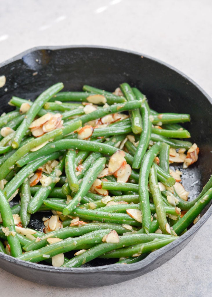Garlic Butter Green Beans are a family favorite! Tender green beans are tossed in a rich butter sauce and topped toasted almonds, each serving is just under 4 net carbs. 