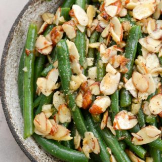 Garlic Butter Green Beans are a family favorite! Tender green beans are tossed in a rich butter sauce and topped toasted almonds, each serving is just under 4 net carbs.