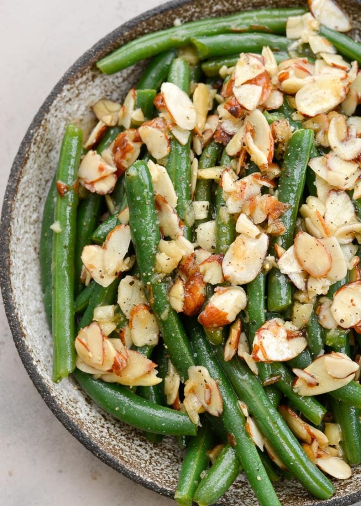 Garlic Butter Green Beans are a family favorite! Tender green beans are tossed in a rich butter sauce and topped toasted almonds, each serving is just under 4 net carbs. 