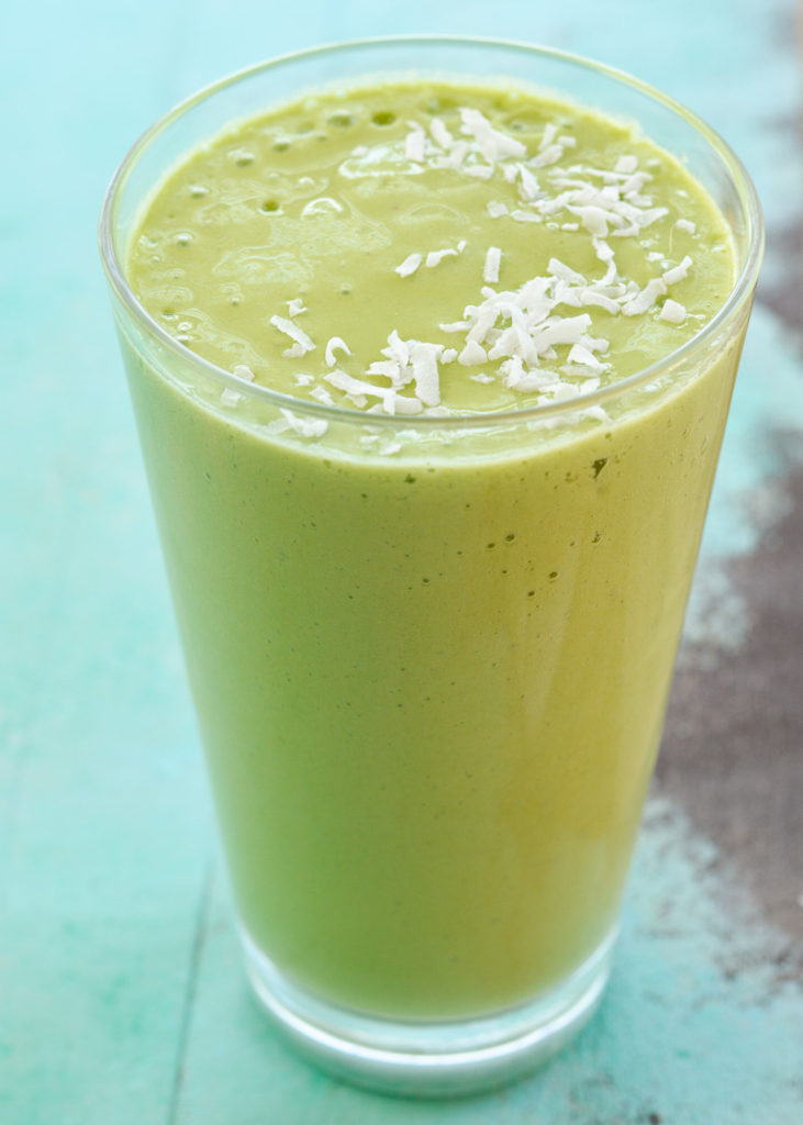This Tropical Green Smoothie is loaded with three varieties of fruit, fresh spinach, coconut milk and juice! This naturally sweetened smoothie packs a big nutritional punch!
