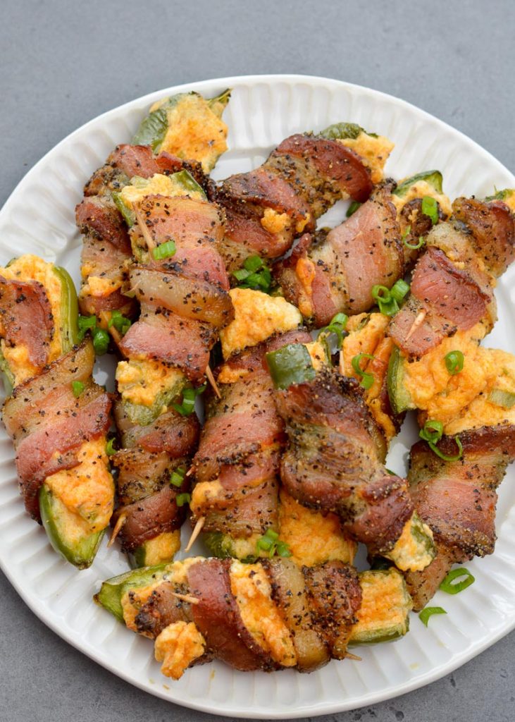 These Keto Jalapeno Poppers are loaded with two kinds of cheese and wrapped in pepper bacon! This easy low carb appetizer can be made in the oven, on the grill or in the air fryer! 