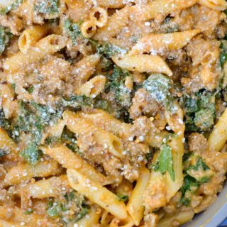 This Sausage and Butternut Squash Pasta features a creamy, lightened up pasta sauce, fresh kale and browned Italian sausage. This is the perfect family friendly dinner recipe that is ready in about 30 minutes!