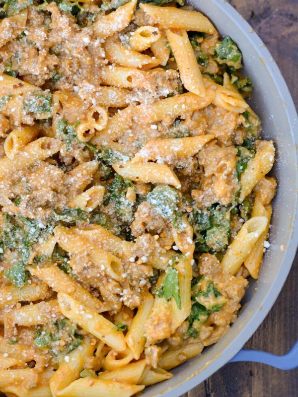 This Sausage and Butternut Squash Pasta features a creamy, lightened up pasta sauce, fresh kale and browned Italian sausage. This is the perfect family friendly dinner recipe that is ready in about 30 minutes!