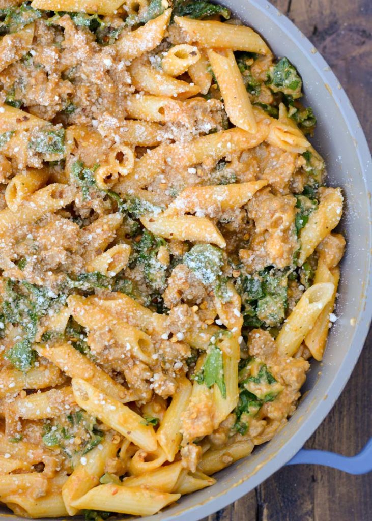 This Sausage and Butternut Squash Pasta features a creamy, lightened up pasta sauce, fresh kale and browned Italian sausage. This is the perfect family friendly dinner recipe that is ready in about 30 minutes! 