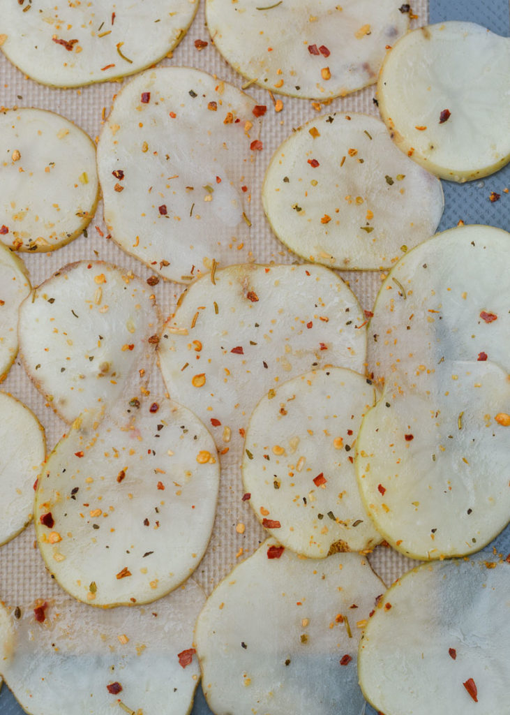 Learn how to make homemade potato chips that are baked instead of fried! This recipe only requires three ingredients and takes less than 20 minutes! 