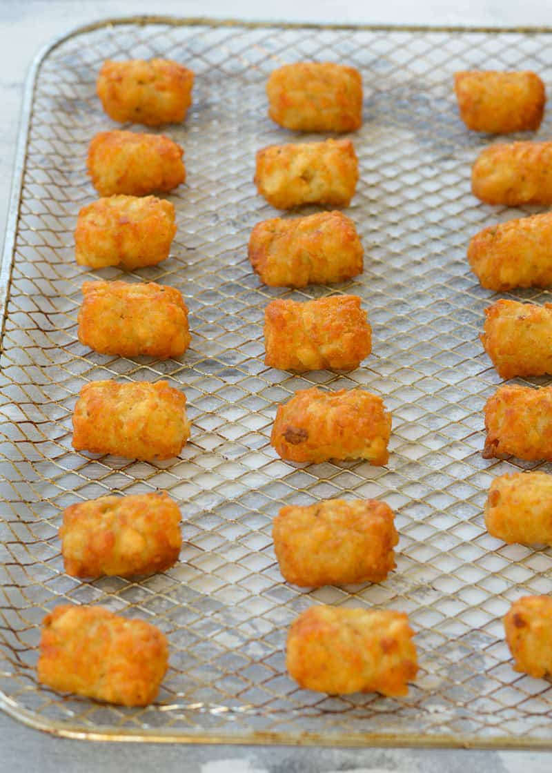 frozen tater tots on an air fryer rack
