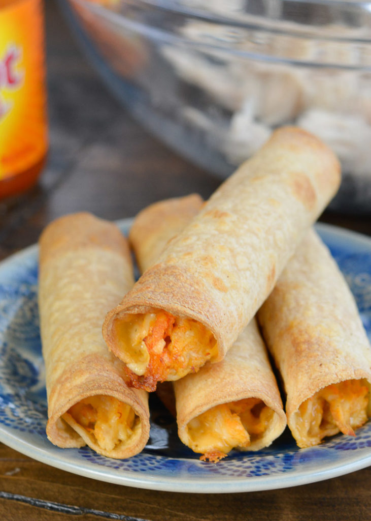 Your whole family won't be able to get enough of these Chicken Taquitos! This easy dinner recipe is loaded with chicken, cheese and buffalo sauce and is ready in under 10 minutes!