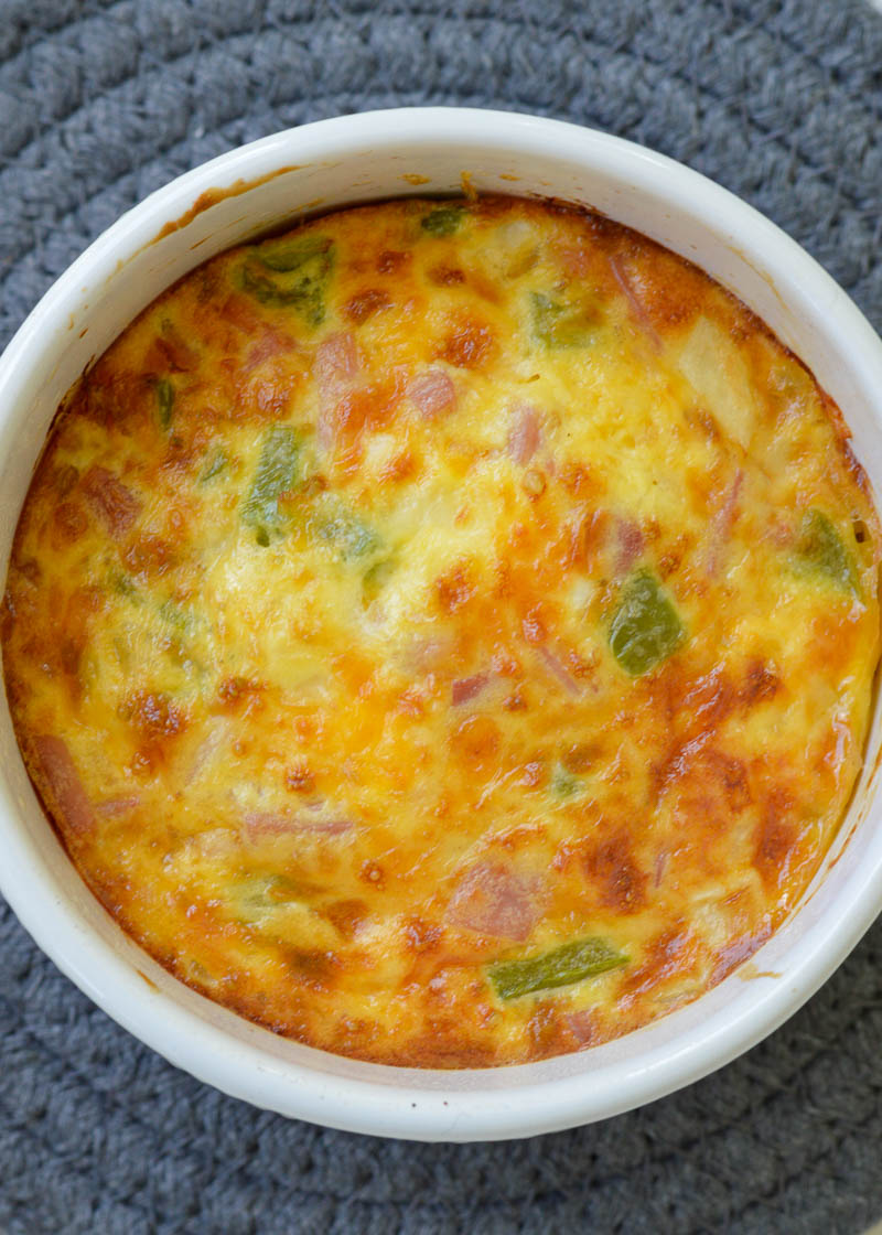 These Air Fryer Eggs are a quick, easy way to enjoy a healthy breakfast! Packed full of bell peppers, onions, ham, and cheddar, it's an easy twist on a Denver Omelet!