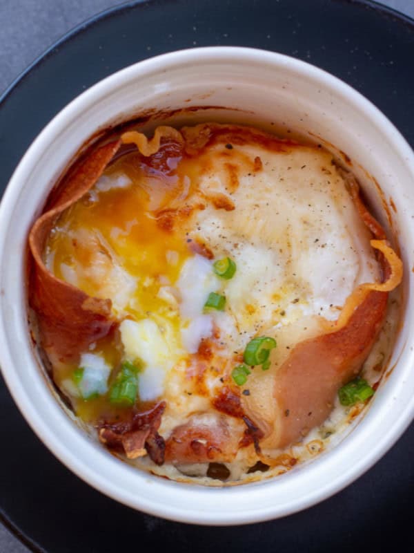 Learn how to make Eggs in the Air Fryer for the ultimate quick and easy breakfast! These easy air fryer eggs feature prosciutto and parmesan and are ready in 10 minutes or less!