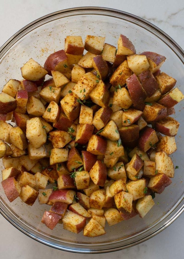 These Air Fryer Breakfast Potatoes require just four ingredients and 15 minutes! These crispy, salty breakfast potatoes are great with bacon and eggs!