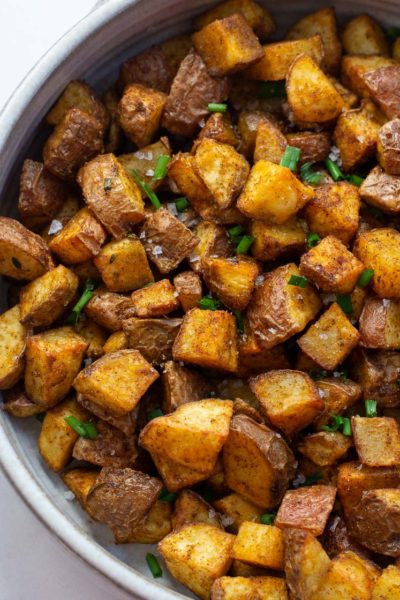 These Air Fryer Breakfast Potatoes require just four ingredients and 15 minutes! These crispy, salty breakfast potatoes are great with bacon and eggs!