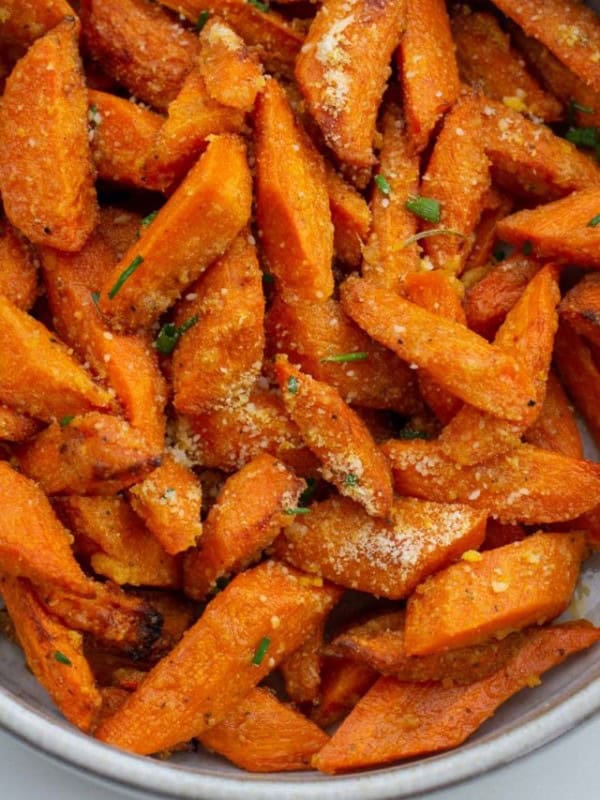 These Air Fryer Carrots are tossed in olive oil, parmesan and spices! These roasted carrots are perfectly tender on the inside and crisp on the outside.
