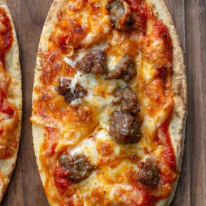 This Air Fryer Pizza requires just 7 minutes of cooking time! You can make your favorite pizza with a crispy, crunchy crust right in your air fryer! This is the perfect weeknight pizza recipe.