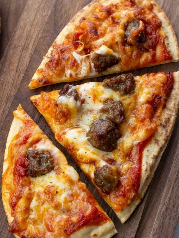 This Air Fryer Pizza requires just 7 minutes of cooking time! You can make your favorite pizza with a crispy, crunchy crust right in your air fryer! This is the perfect weeknight pizza recipe.