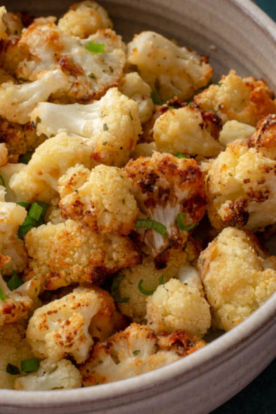 This is the Best Air Fryer Cauliflower recipe! This cauliflower is loaded with flavor and super crispy on the outside while being perfectly tender on the inside! This easy air fryer vegetable recipe is ready in less than 15 minutes!