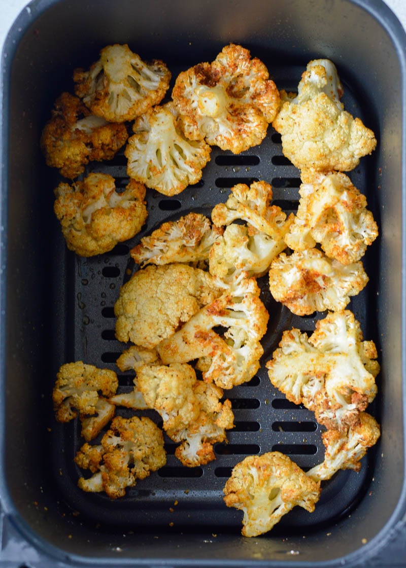 This delicious Air Fryer Parmesan Cauliflower is tossed in a delicious garlic parmesan sauce and cooked to crispy perfection! Just 4 net carbs for a full cup of this buttery side dish.