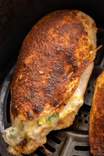 This easy Air Fryer Stuffed Chicken Breast recipe is perfect for a busy weeknight! Naturally gluten free, low carb, and bursting with cheesy, spicy flavor!