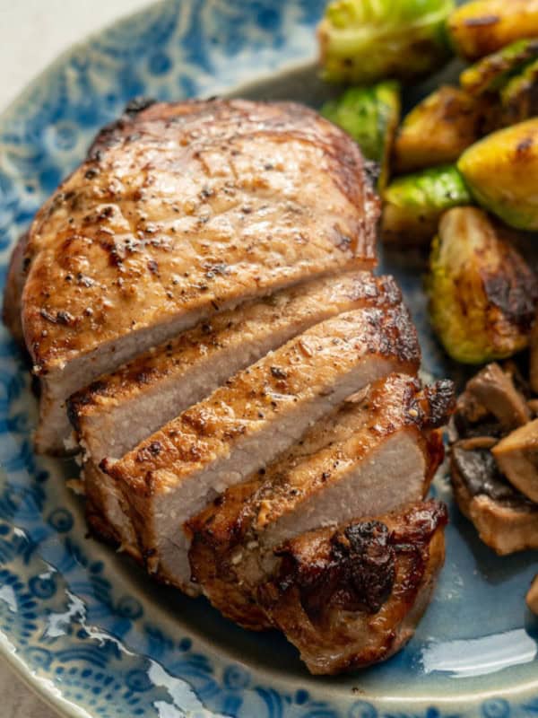 These Air Fryer Pork Chops is a 20 minute recipe perfect for weekday nights! Cooking pork chops in the air fryer gives you juicy, tender, perfect pork chops.