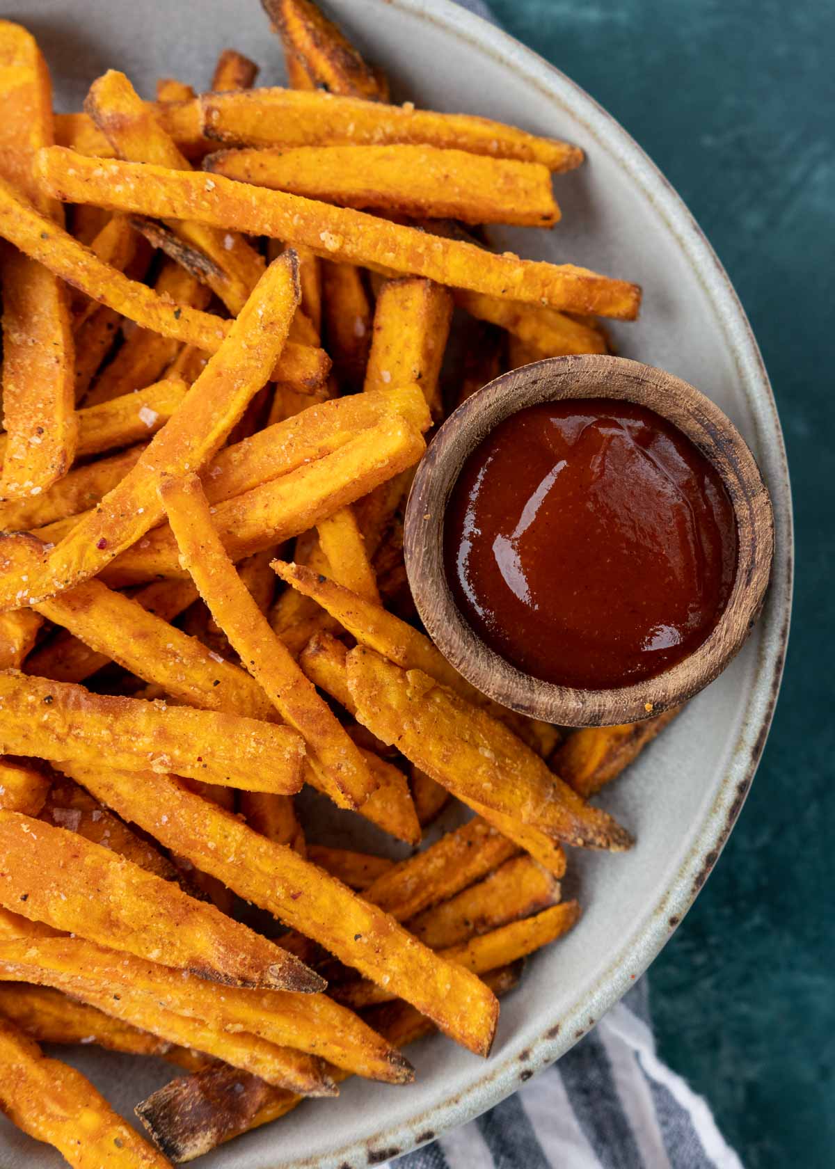 Sweet potato fries and sauce on a white plate