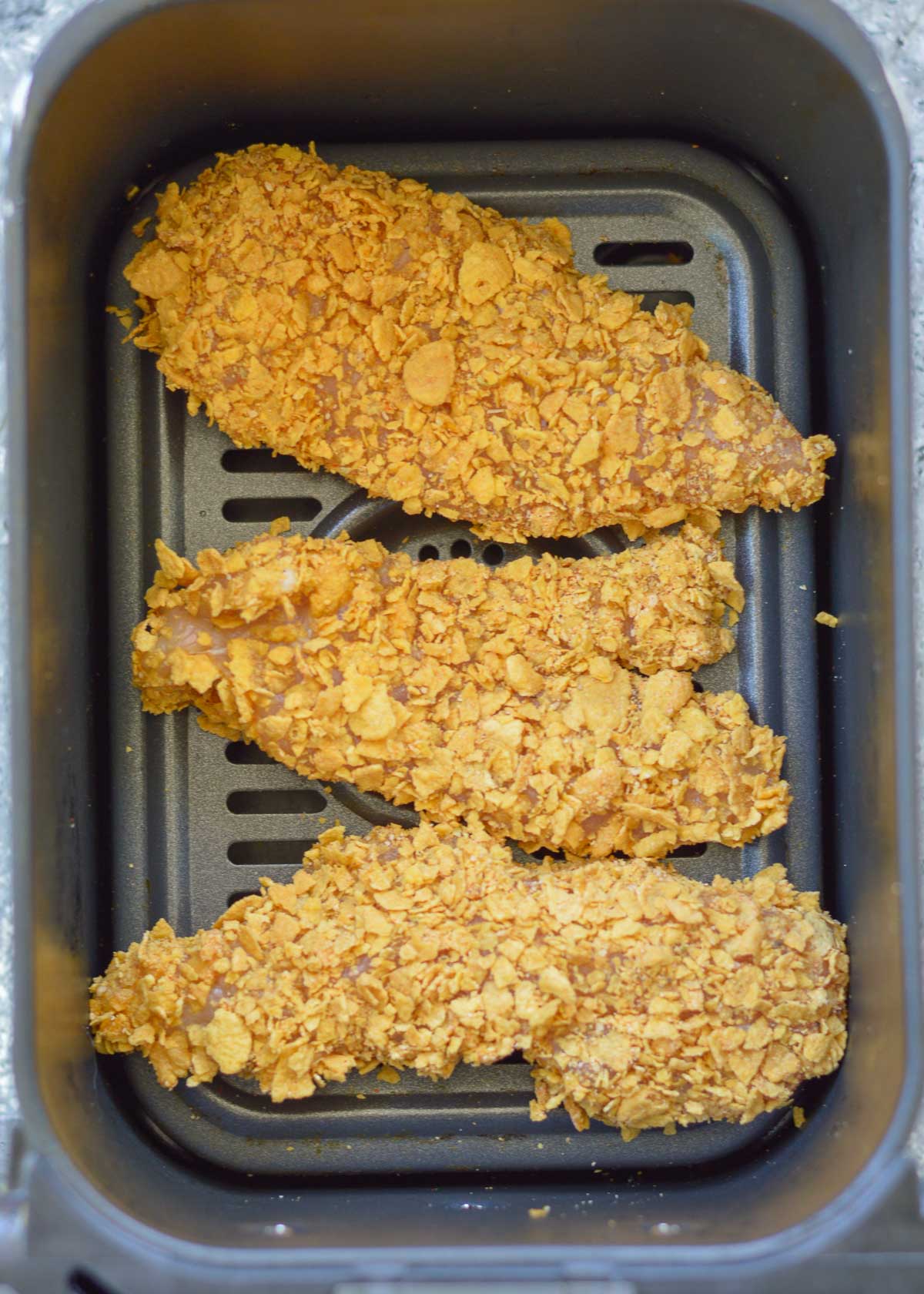 These Crispy Air Fryer Chicken Tenders are ready with less than 10 minutes in the air fryer! Parmesan, cornflakes, and a tasty Italian seasoning give these juicy chicken strips loads of flavor.