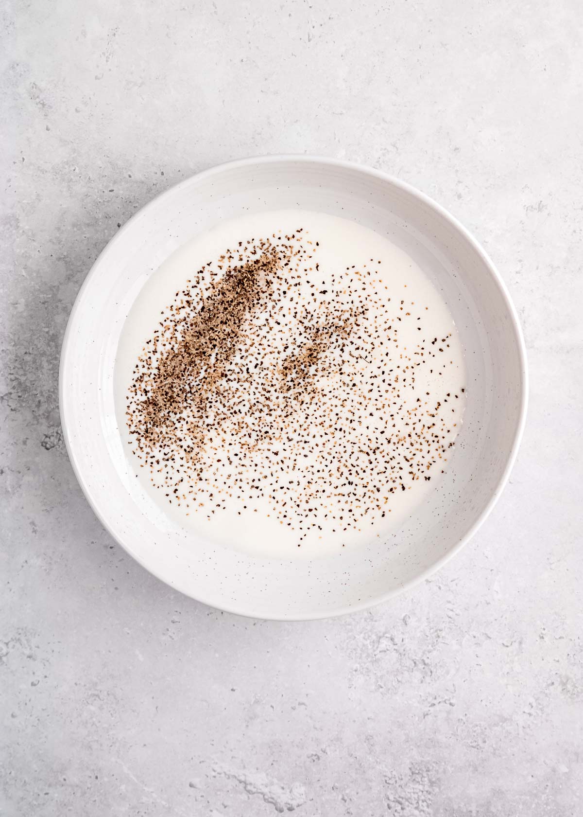 buttermilk, salt and pepper in bowl