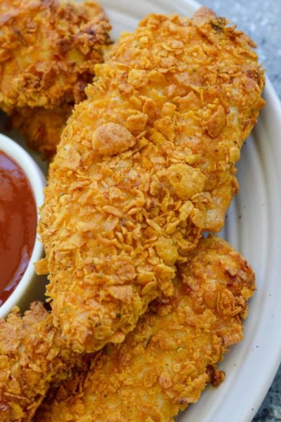 These Crispy Air Fryer Chicken Tenders are ready with less than 10 minutes in the air fryer! Parmesan, cornflakes, and a tasty Italian seasoning give these juicy chicken strips loads of flavor.