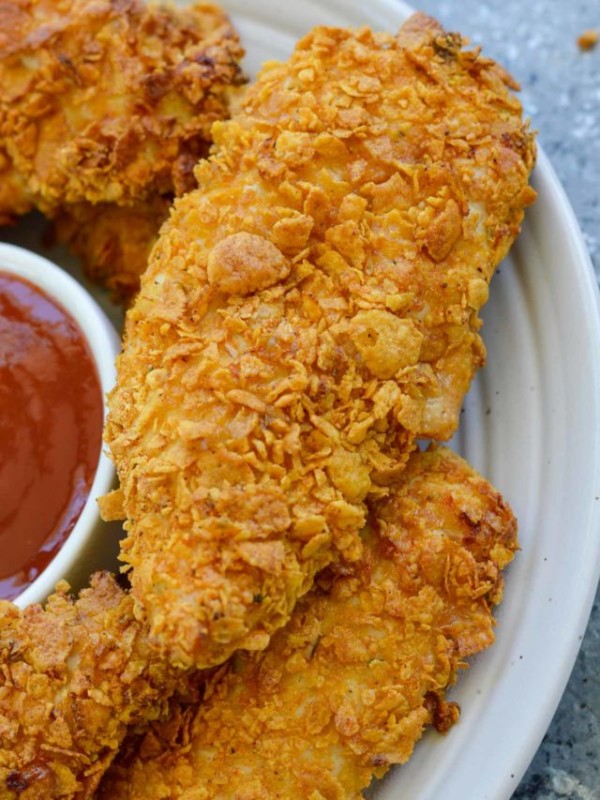 These Crispy Air Fryer Chicken Tenders are ready with less than 10 minutes in the air fryer! Parmesan, cornflakes, and a tasty Italian seasoning give these juicy chicken strips loads of flavor.