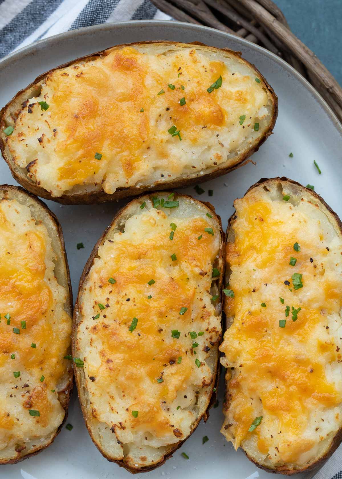 These Air Fryer Twice Baked Potatoes are the perfect side dish or appetizer! Get that cheesy center and ultra-crispy potato skin quickly with this easy recipe.