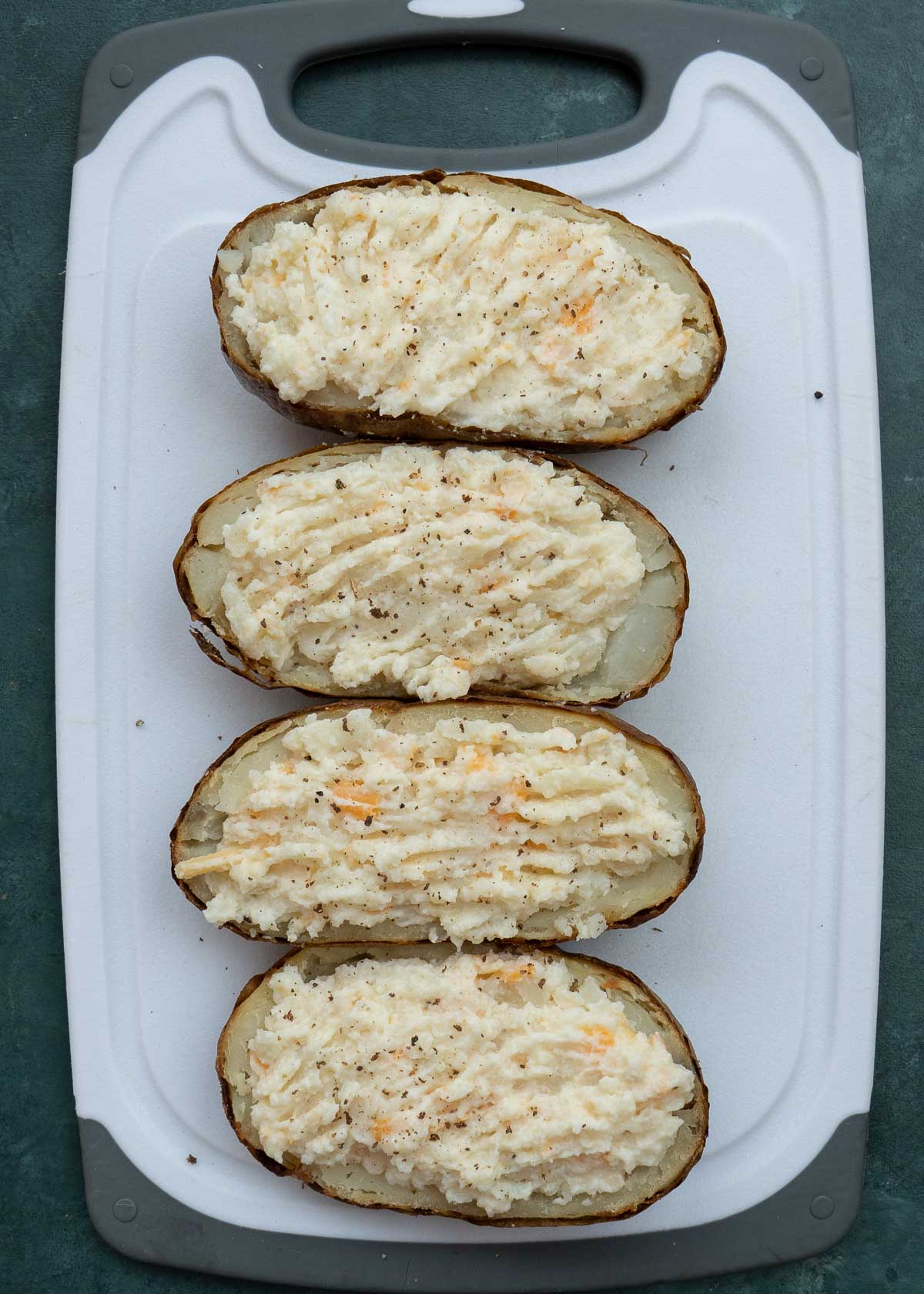 scoop the creamy, well-mixed filling into the hollowed potato skins