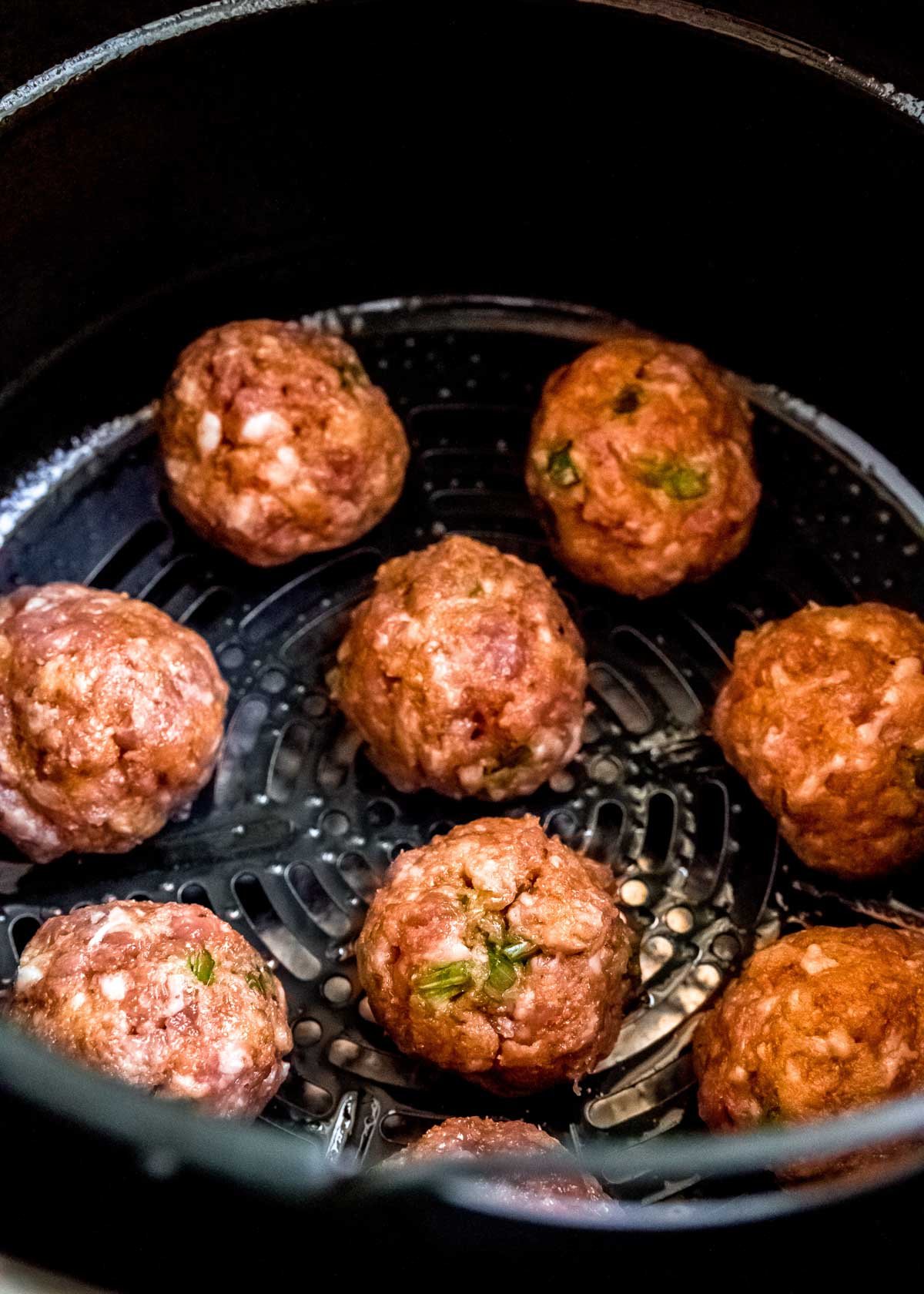 place meatballs in the air fryer with about 1" of space between each