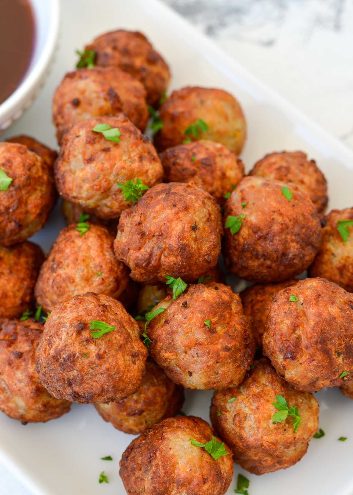 Whether you serve them covered in sauce or plain and ready to dip, air fryer meatballs are a juicy, delicious side dish you can make quickly!