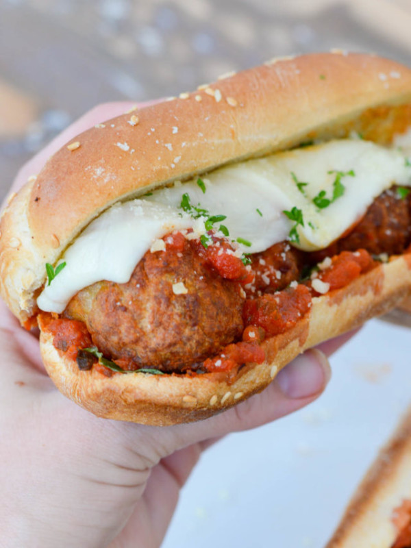 hand holding a meatball sub