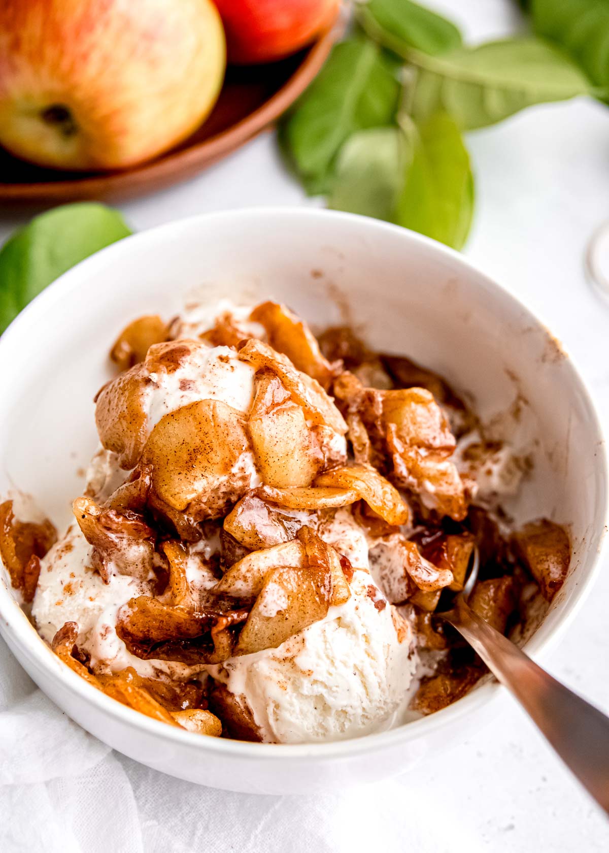 air fryer apples over a bowl of ice cream