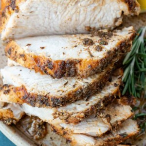 a sliced, seasoned turkey breast on a plate