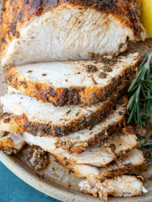 a sliced, seasoned turkey breast on a plate