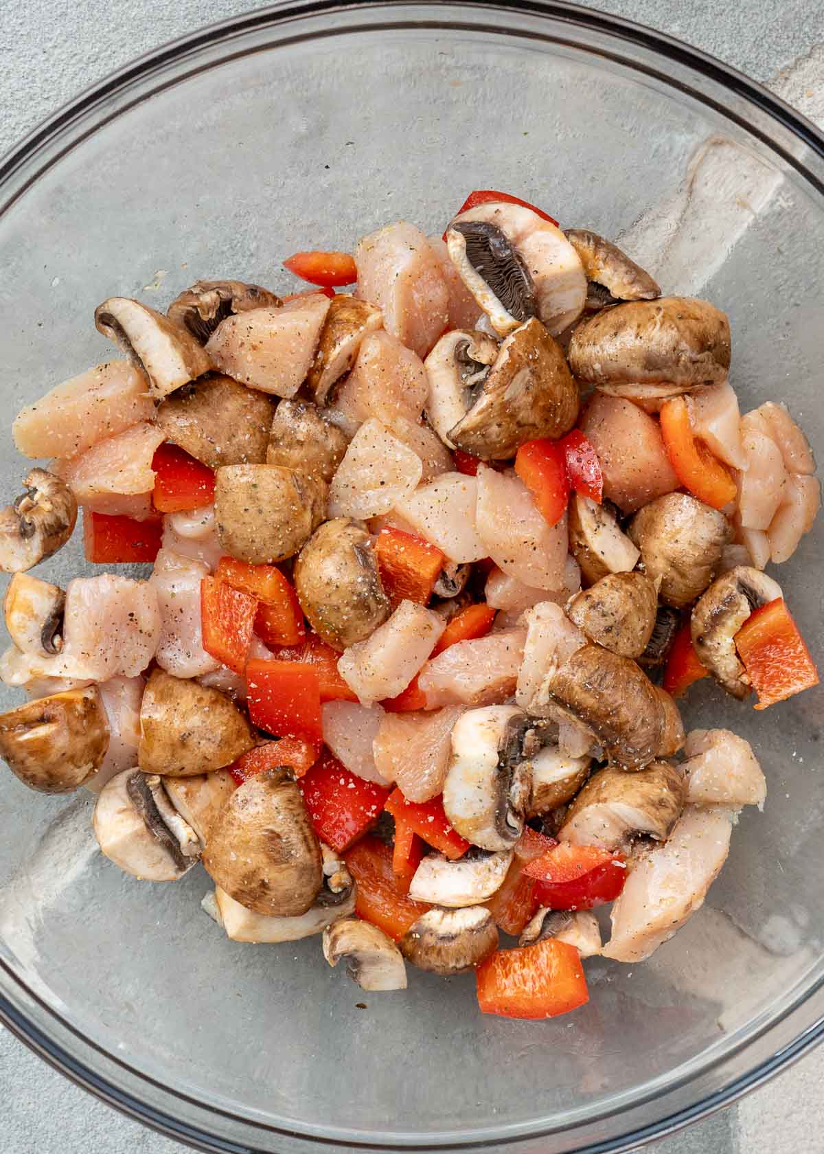 peppers, chicken, and mushrooms mixed with olive oil, salt, and pepper
