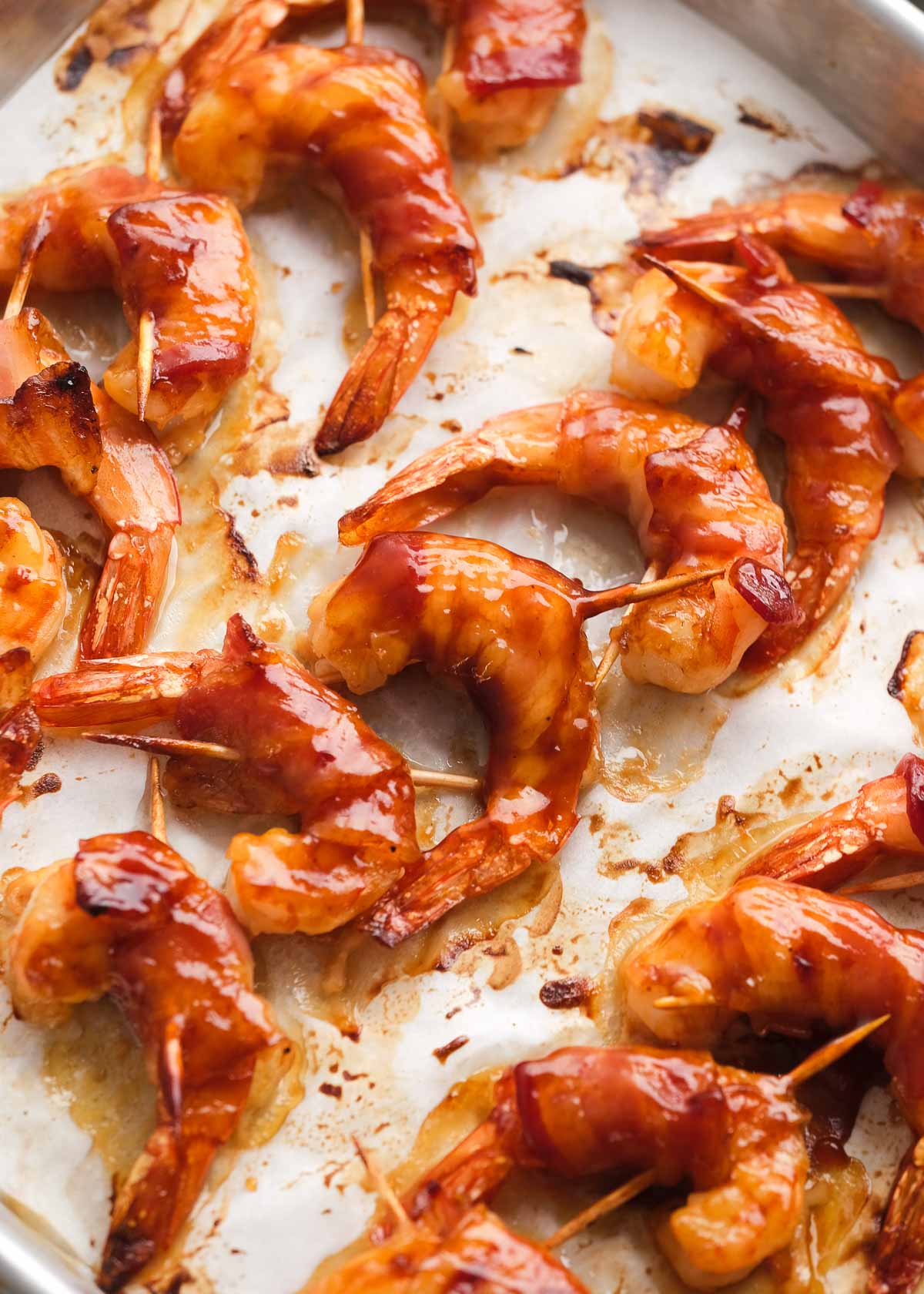 bacon-wrapped shrimp on a baking sheet