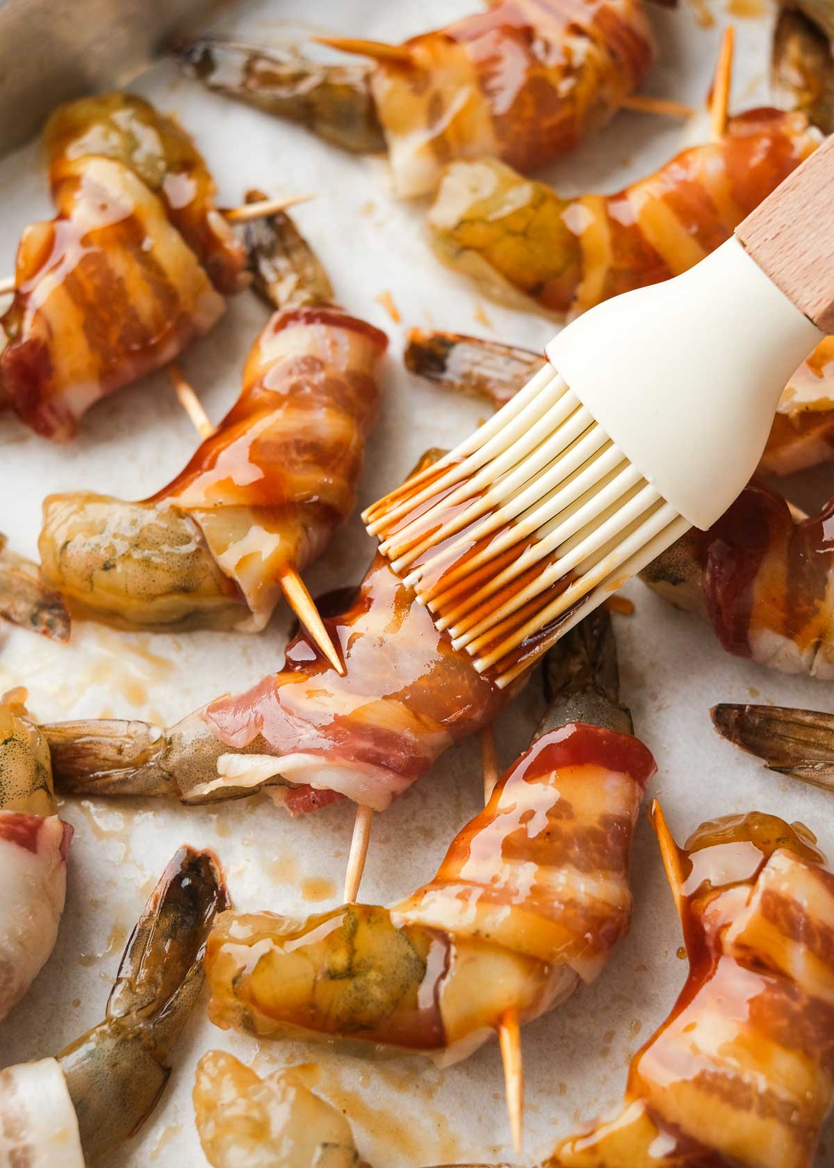 brush bacon wrapped shrimp with bbq sauce, sweetener, and vinegar mixture