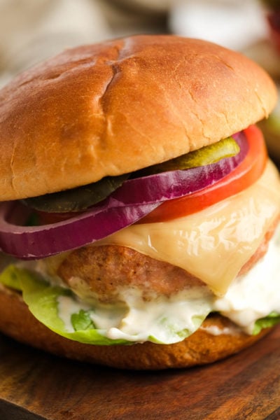 air fryer turkey burger with cheese, lettuce, tomato, pickles, mayonnaise, and red onions