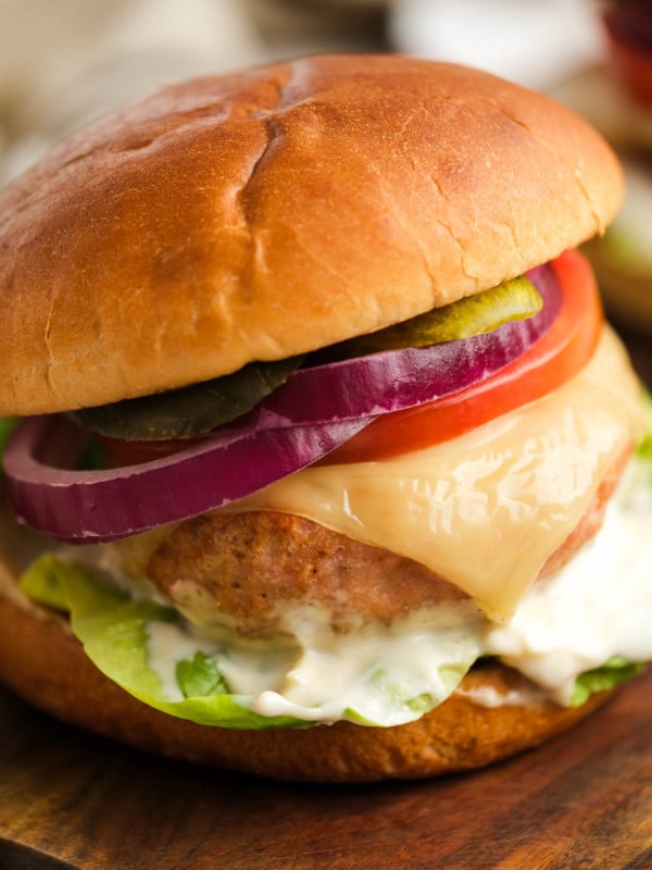 air fryer turkey burger with cheese, lettuce, tomato, pickles, mayonnaise, and red onions