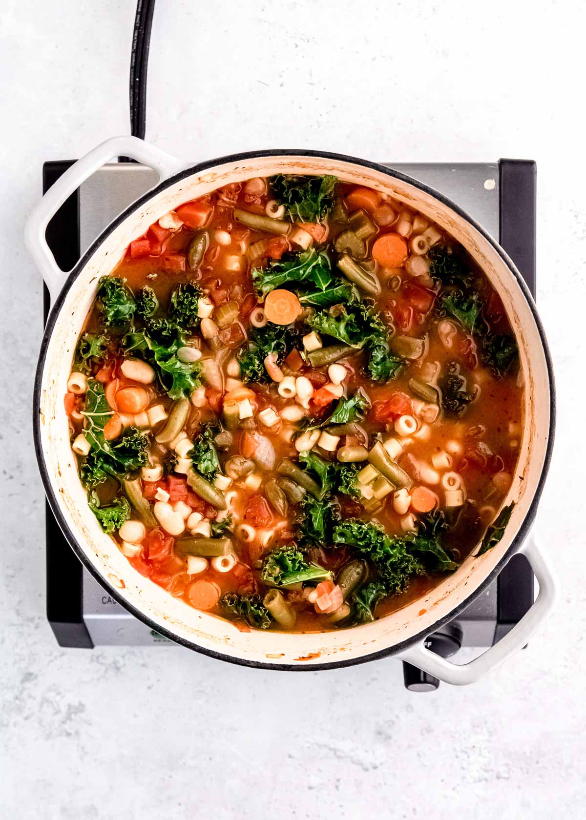 minestrone soup with all ingredients stirred into the pot