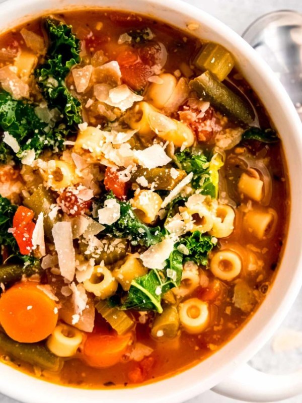 a hearty bowl of minestrone soup garnished with parmesan