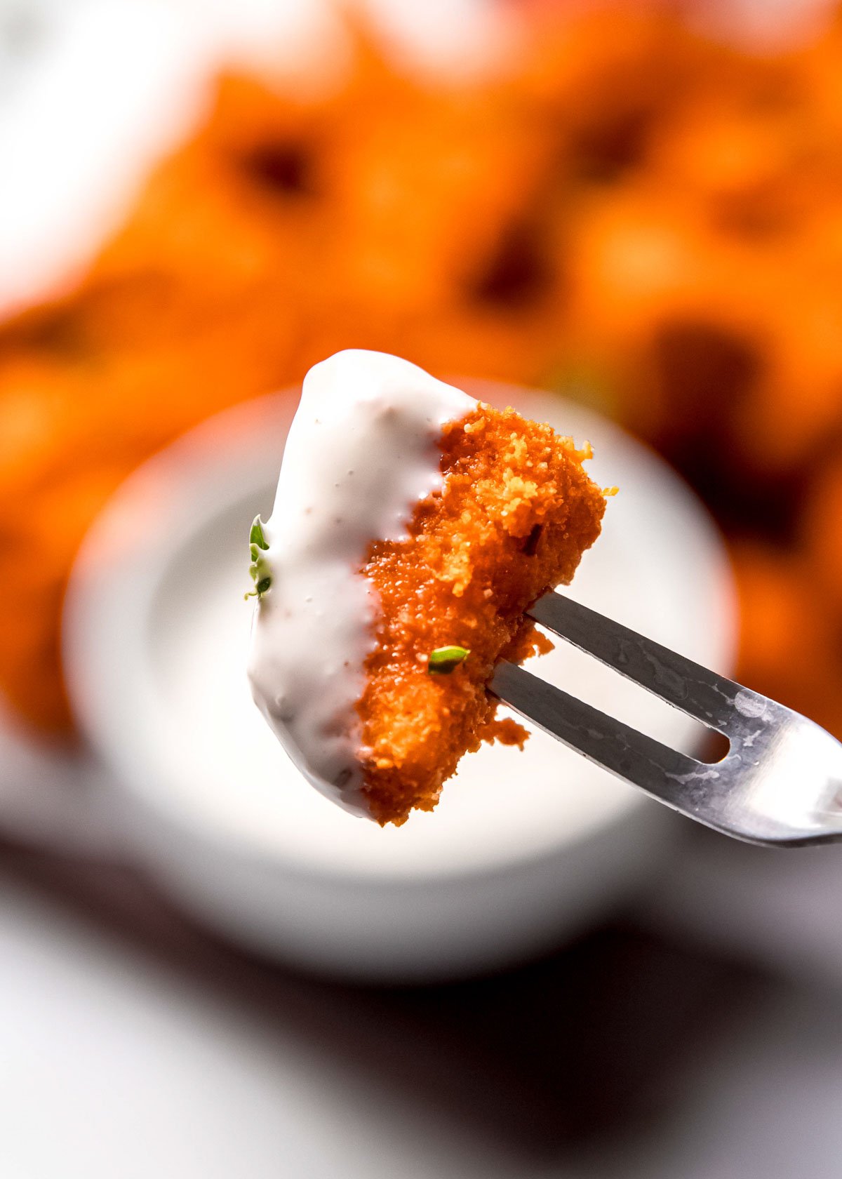 close up of buffalo chicken bite dipped in ranch dressing