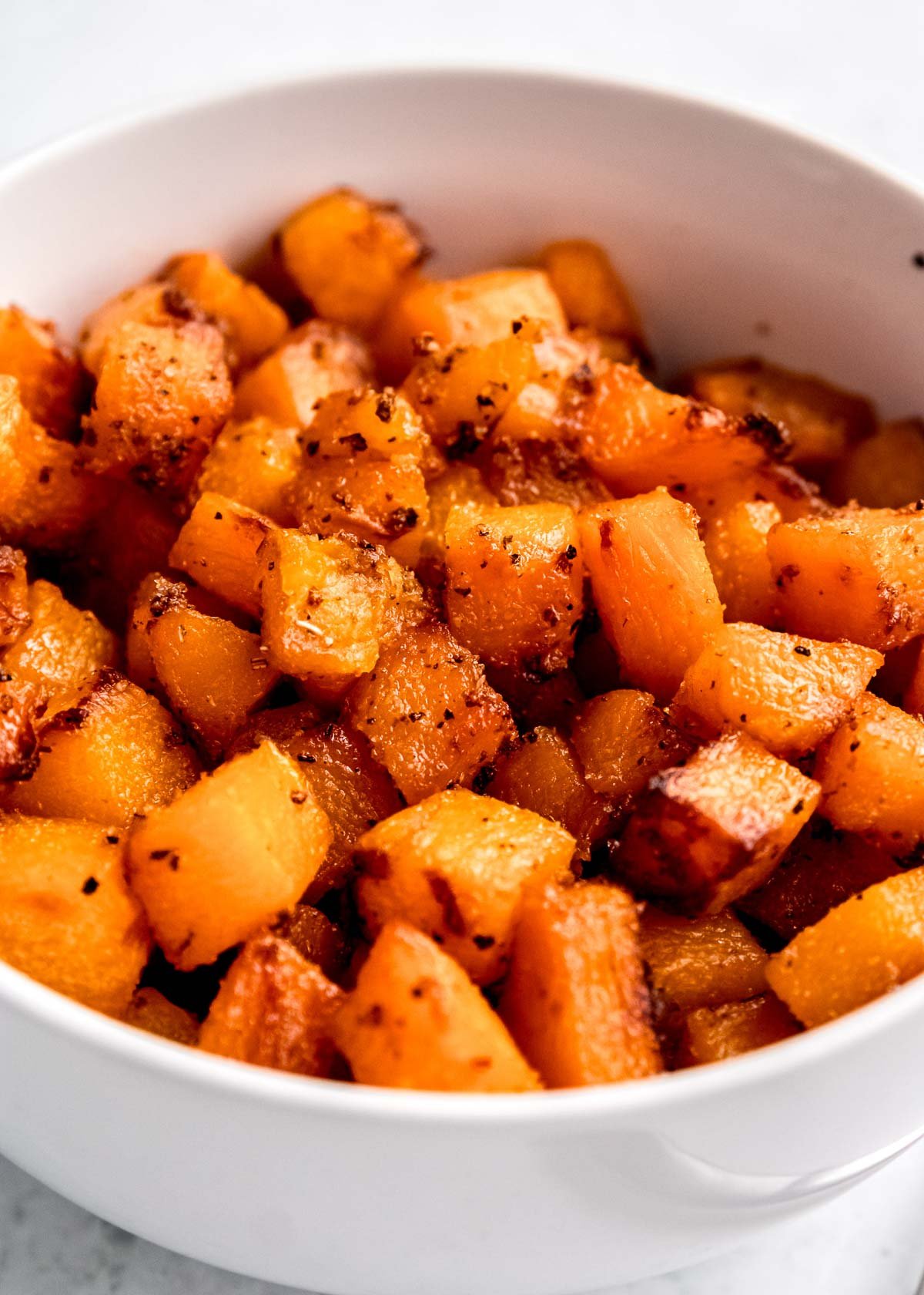 cubed air fryer butternut squash in white bowl